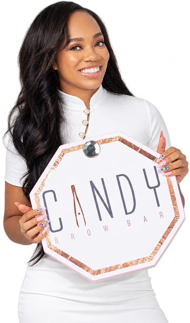 Candy holding the Candy Brow Bar sign